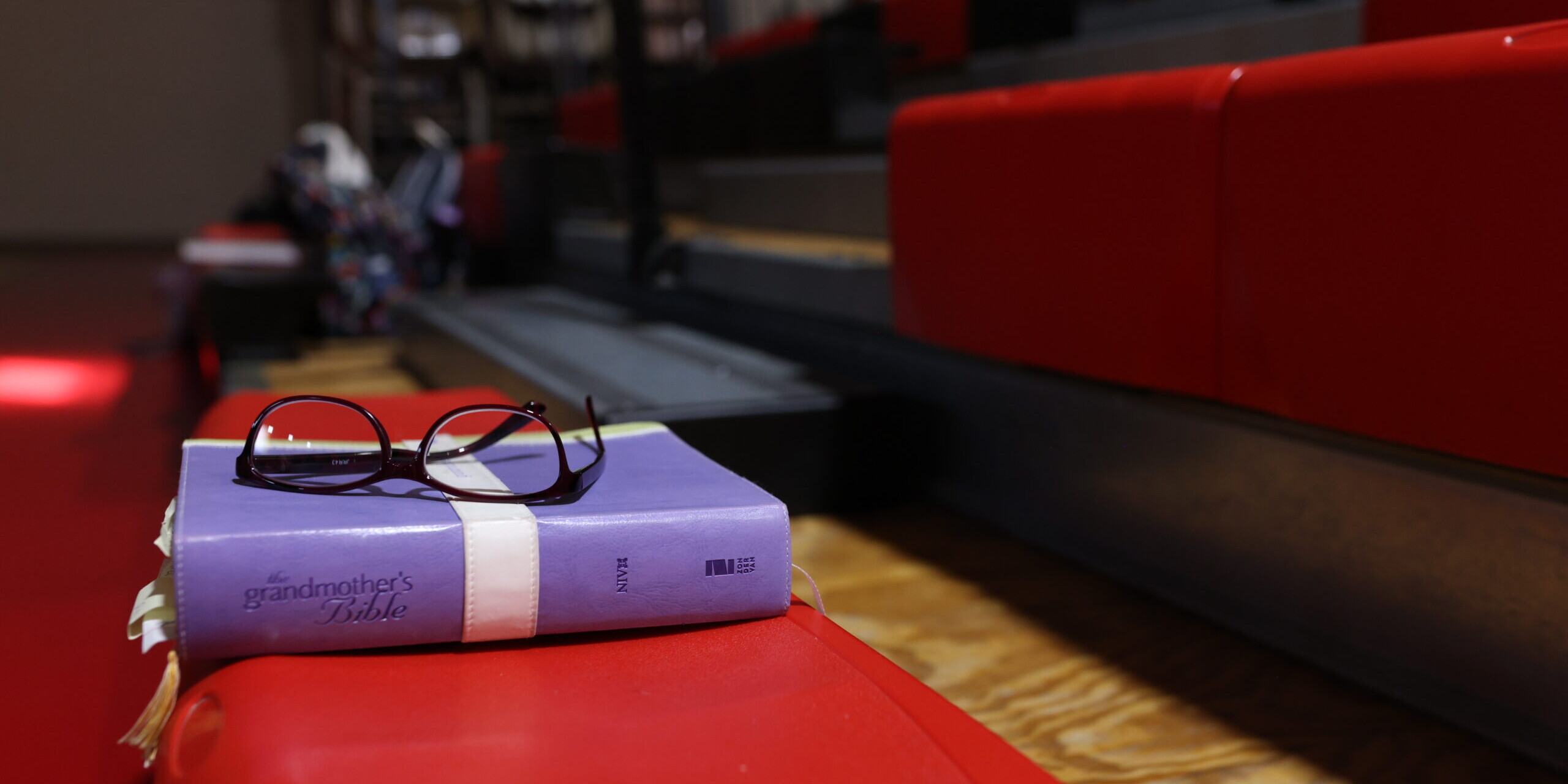bible and glasses on bleacher